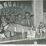 1951: "Headless effigy propped up on table behind candles and sign reading, 'Dressen No Head;' onlookers peering in from outside storefront window of Bud and Packy's Bar, 199 Richards St., decapitated dummy illustrates one view of Dodger manager's ninth-inning strategy in choosing Ralph Branca as relief pitcher who tossed the ball that Bobby Thomson hit for the home run that lost the 1951 pennant."